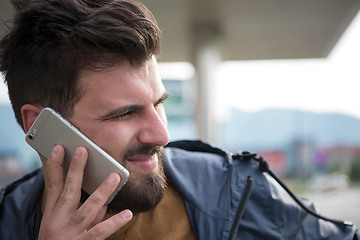 Image showing handsome young casual business man with beard using cell phone