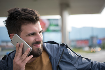 Image showing handsome young casual business man with beard using cell phone