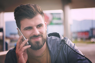 Image showing handsome young casual business man with beard using cell phone