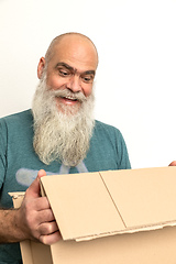 Image showing pleased looking bearded man with a carton box