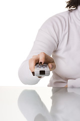 Image showing Holding and pointing a remote control