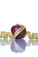 Image showing Red apple over a measure tape