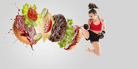 Image showing Burger\'s crashing by the boxer isolated on white background