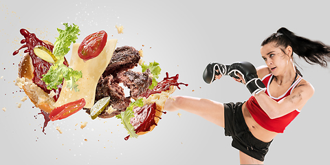 Image showing Burger\'s crashing by the boxer isolated on white background