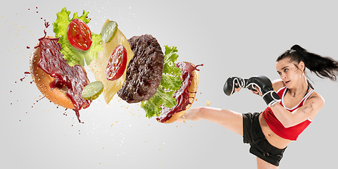 Image showing Burger\'s crashing by the boxer isolated on white background