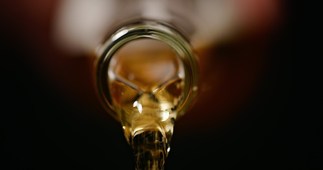 Image showing Beer being poured against dark background with slow movements