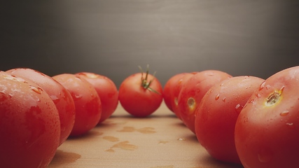 Image showing Macro footage in motion of some tomatoes on the table