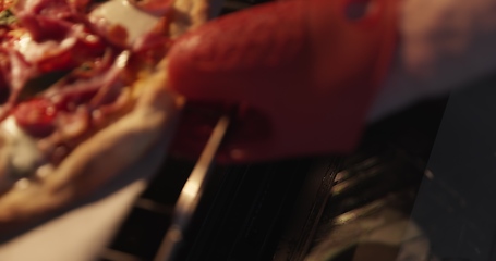 Image showing Homemade pizza being checked on in oven