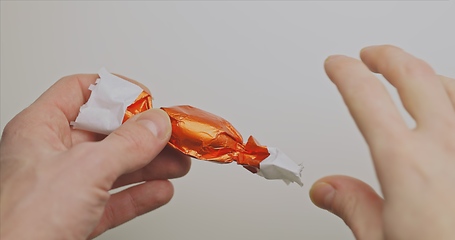 Image showing Man opening christmas choclate closeup footage