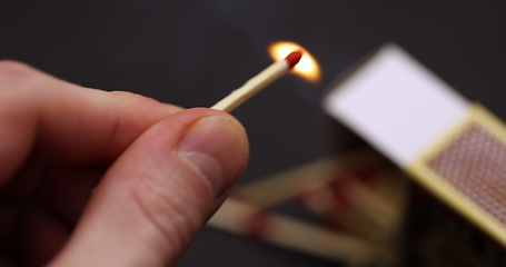 Image showing Lighting up Match in hand slow motion footage