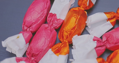 Image showing Christmas candy lying on the table with camera in motion closeup