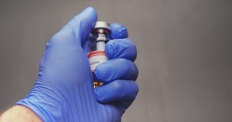 Image showing Vaccine in human hands closeup footage