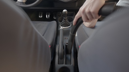 Image showing Man cleaning dirty car interior with vacuum cleaner