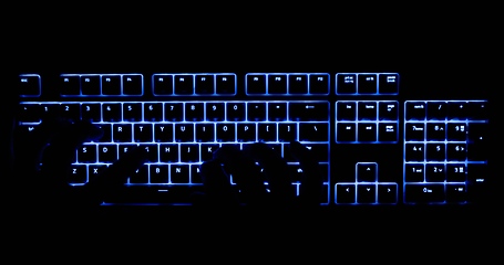 Image showing Hands typing in the dark on illuminated keyboard