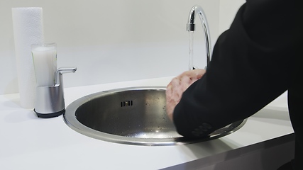 Image showing Washing hands in white sink