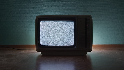 Image showing Old TV agains green background