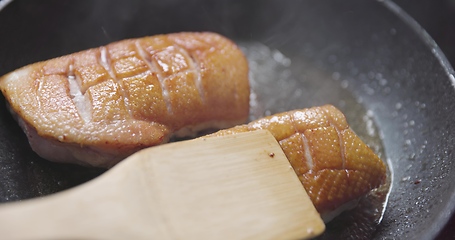 Image showing Roast duck breast in frying pen closeup footage