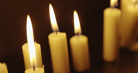 Image showing Candles glowing against dark background