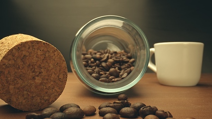 Image showing Roasted coffee beans on table in camera motion