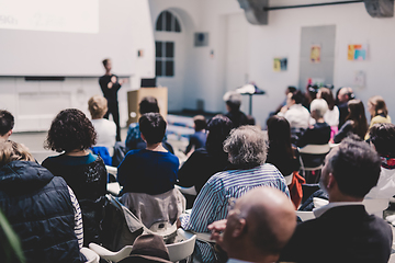 Image showing Woman giving presentation in lecture hall at university.