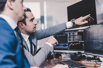 Image showing Stock brokers looking at computer screens, trading online.