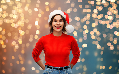 Image showing happy young woman in santa hat on christmas