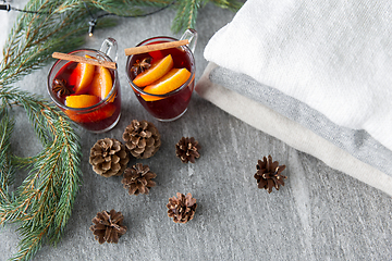 Image showing mulled wine with orange and spices, cones and fir