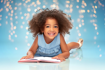 Image showing smiling little african american girl reading book