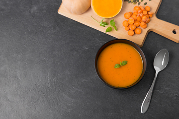 Image showing vegetable pumpkin cream soup in bowl with spoon