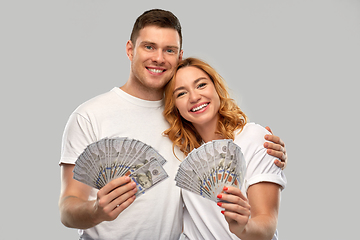 Image showing happy couple in white t-shirts with dollar money