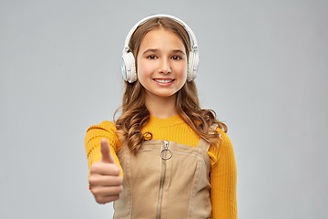 Image showing teenage girl in headphones showing thumbs up