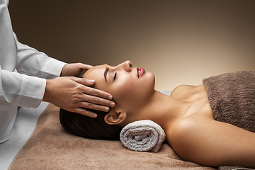 Image showing woman having face and head massage at spa