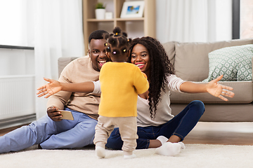 Image showing african family playing with baby daughter at home