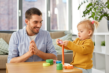 Image showing father playing with little baby daughter at home