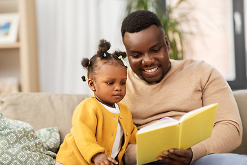 Image showing african father reading book for baby daughter