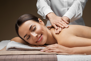 Image showing woman lying and having back massage at spa