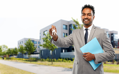 Image showing indian man realtor with key and folder in city