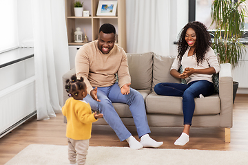 Image showing african family playing with baby daughter at home