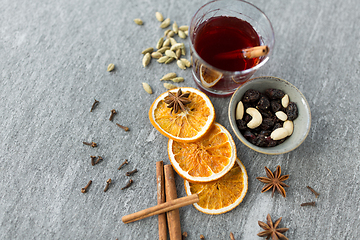 Image showing hot mulled wine, orange slices, raisins and spices