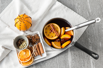 Image showing pot with hot mulled wine, orange slices and spices