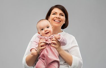 Image showing happy middle-aged mother with little baby daughter