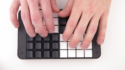 Image showing Hands typing fast on Unlabeled keyboard