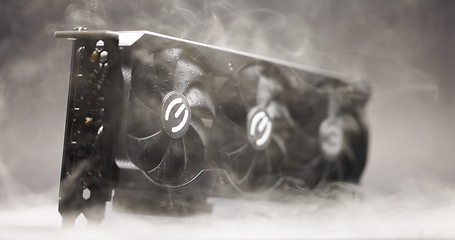 Image showing Graphics card with smoke rising and dark background