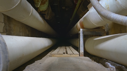 Image showing Dark underground tunnel made out of pipes