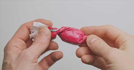 Image showing Man opening christmas choclate closeup footage