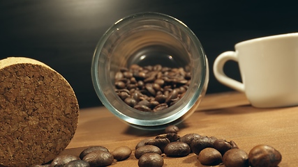 Image showing Roasted coffee beans on table in camera motion