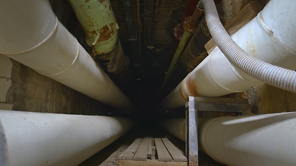 Image showing Dark underground tunnel made out of pipes