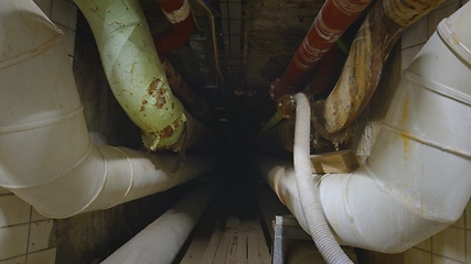 Image showing Dark underground tunnel made out of pipes