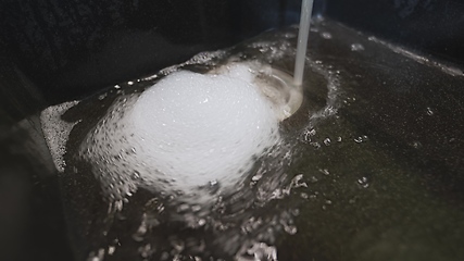 Image showing Foam and water whirling in wash basin