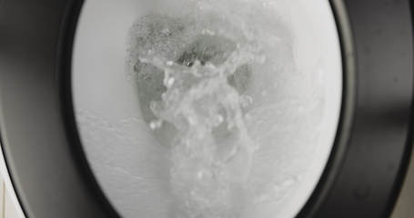 Image showing Flushing down toilet closeup footage 4K 120fps slow motion